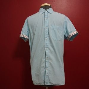 light blue button up shirt with pattern cuffs
